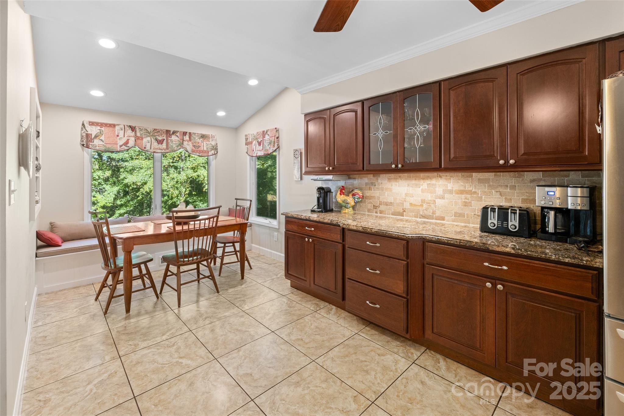 1326 Clifflure Lane Fort Mill, SC 29708 - Photo 18 of 47 a kitchen with stainless steel appliances granite countertop wooden cabinets a dining table and chairs