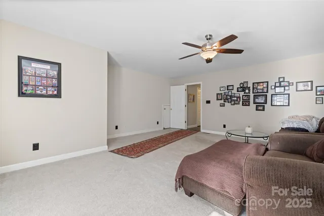 a spacious bedroom with a bed and a ceiling fan