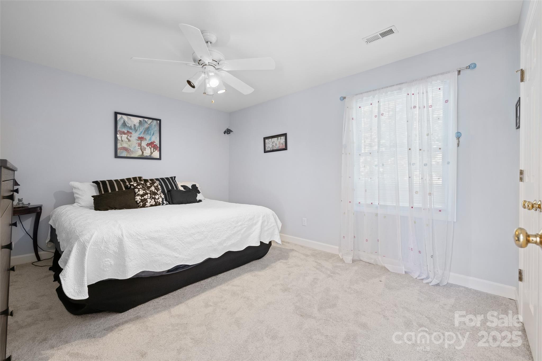 1326 Clifflure Lane Fort Mill, SC 29708 - Photo 29 of 47 a bedroom with a large bed and a chandelier