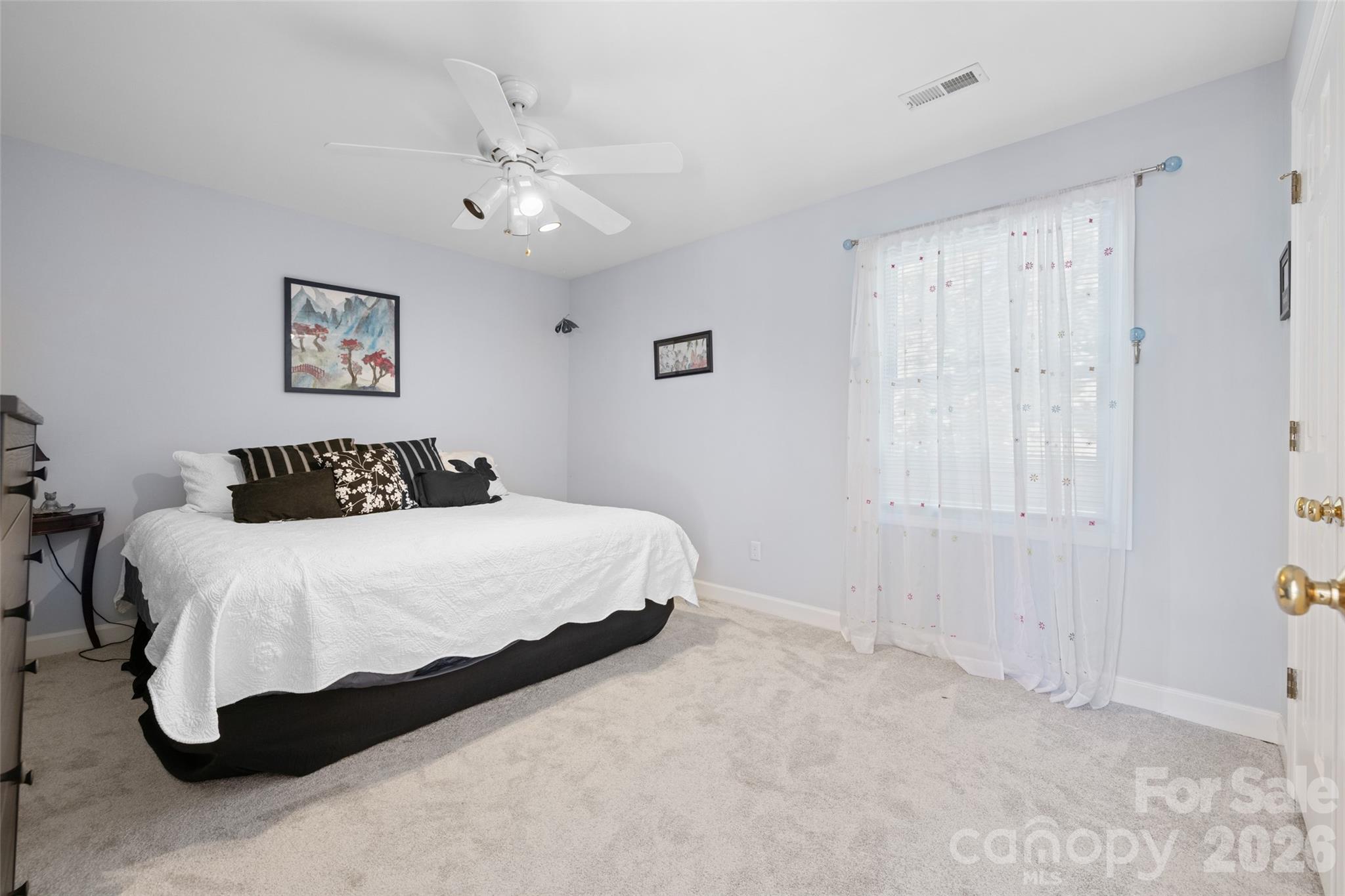 1326 Clifflure Lane Fort Mill, SC 29708 - Photo 29 of 46 a bedroom with a large bed and a chandelier