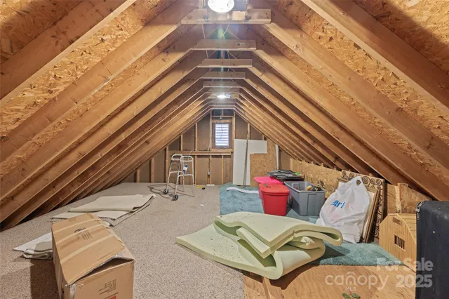 a roof deck with couch and chairs