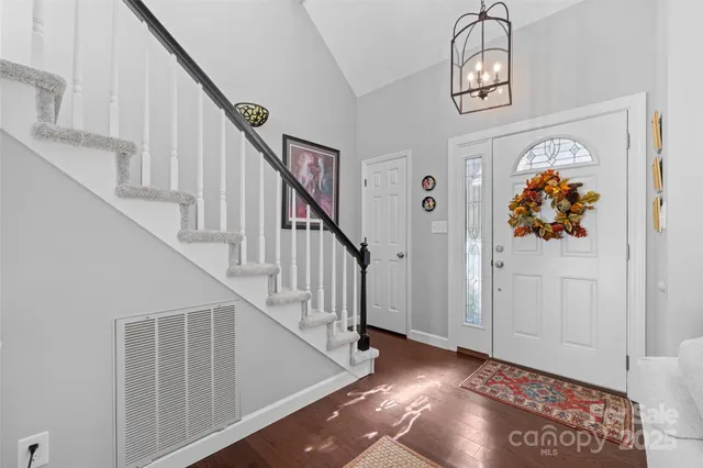 a view of entryway and hall with wooden floor