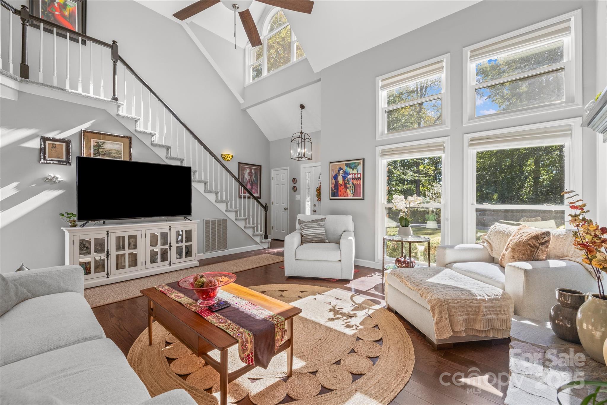 1326 Clifflure Lane Fort Mill, SC 29708 - Photo 7 of 47 a living room with furniture a flat screen tv and a floor to ceiling window
