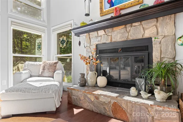 a living room with furniture a window and a fireplace