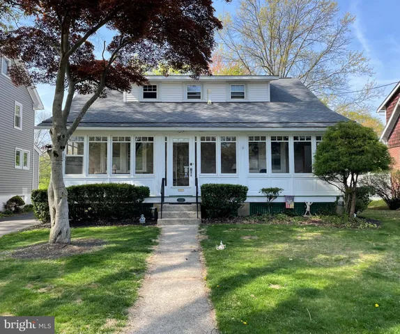 a view of a house with a yard porch and sitting area