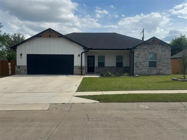 a front view of house with yard and green space