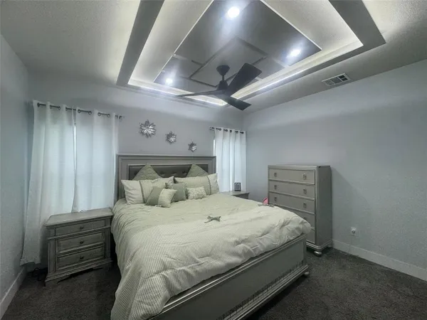 a bedroom with a bed and a chandelier
