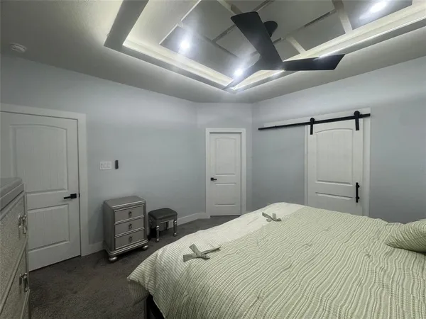 a bedroom with a bed and a tv