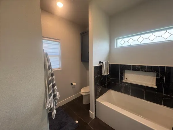 a bathroom with a bathtub and a toilet