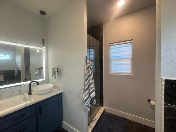 a bathroom with a sink a vanity and a mirror