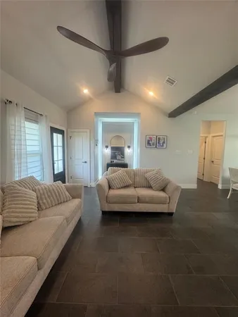 a living room with furniture and a chandelier