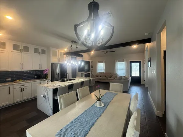 a large white kitchen with a large window