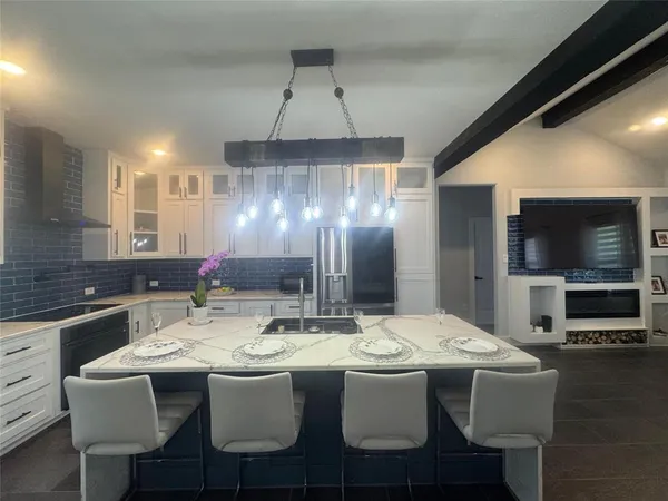 a kitchen with a dining table and chairs