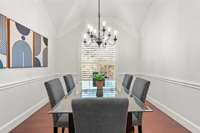 a view of a dining room with furniture and chandelier