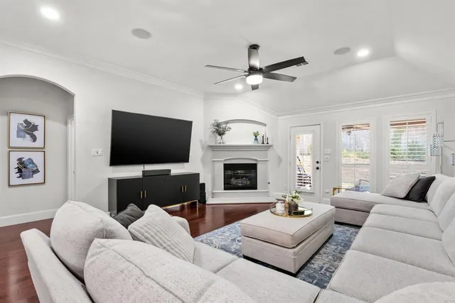 a living room with furniture a flat screen tv and a fireplace