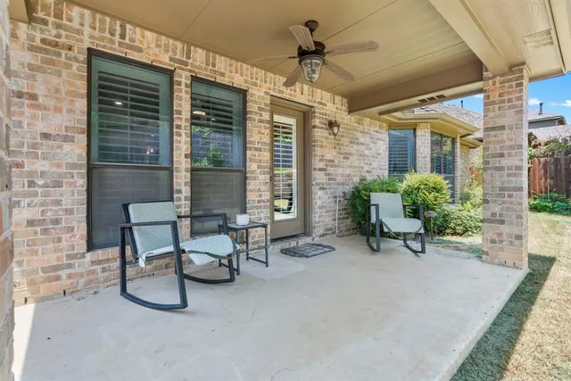 a view of a patio with a table and chairs