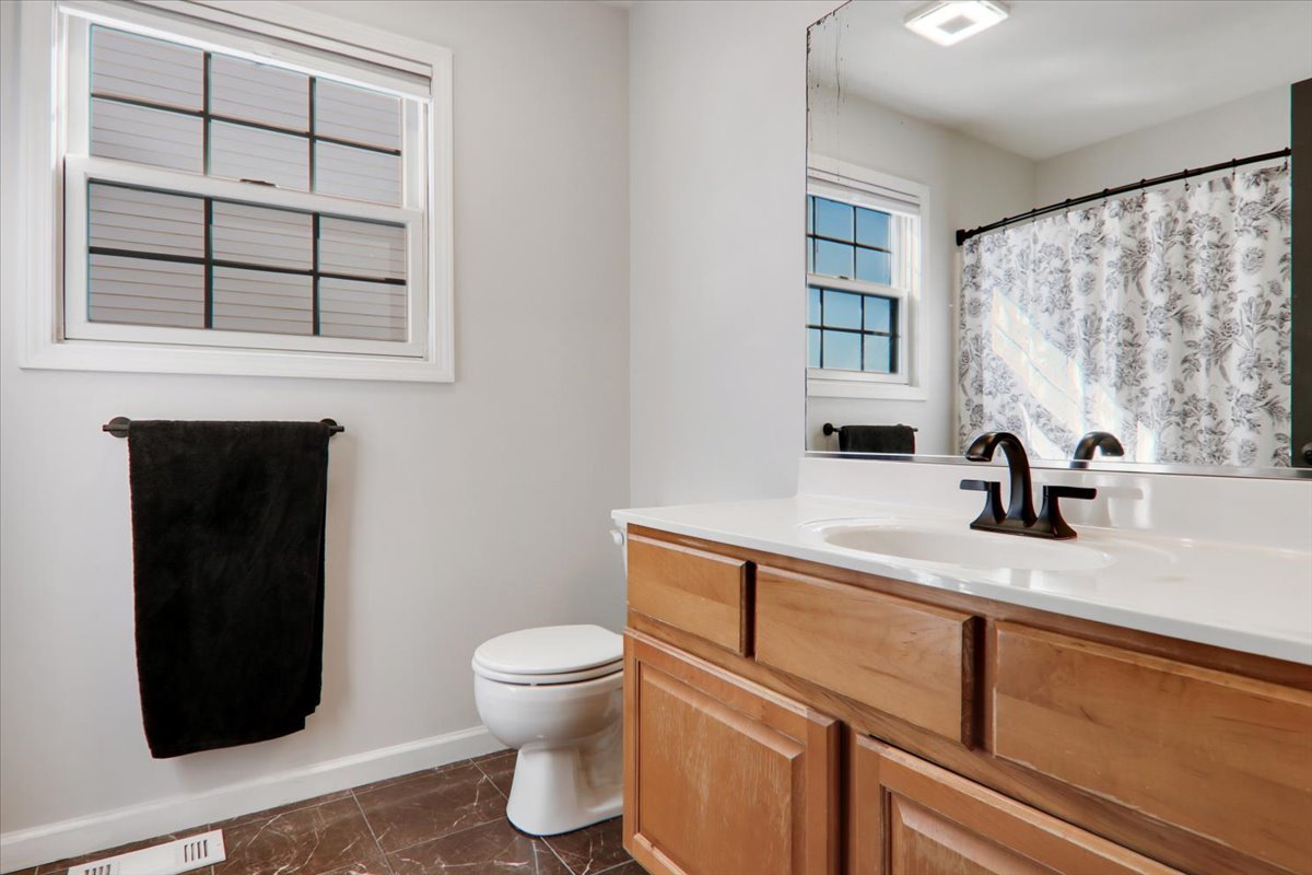 910 Drayton Street Normal, IL 61761 - Photo 12 of 30 a bathroom with a toilet sink and mirror