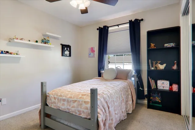 a bedroom with a bed and a painting on the wall