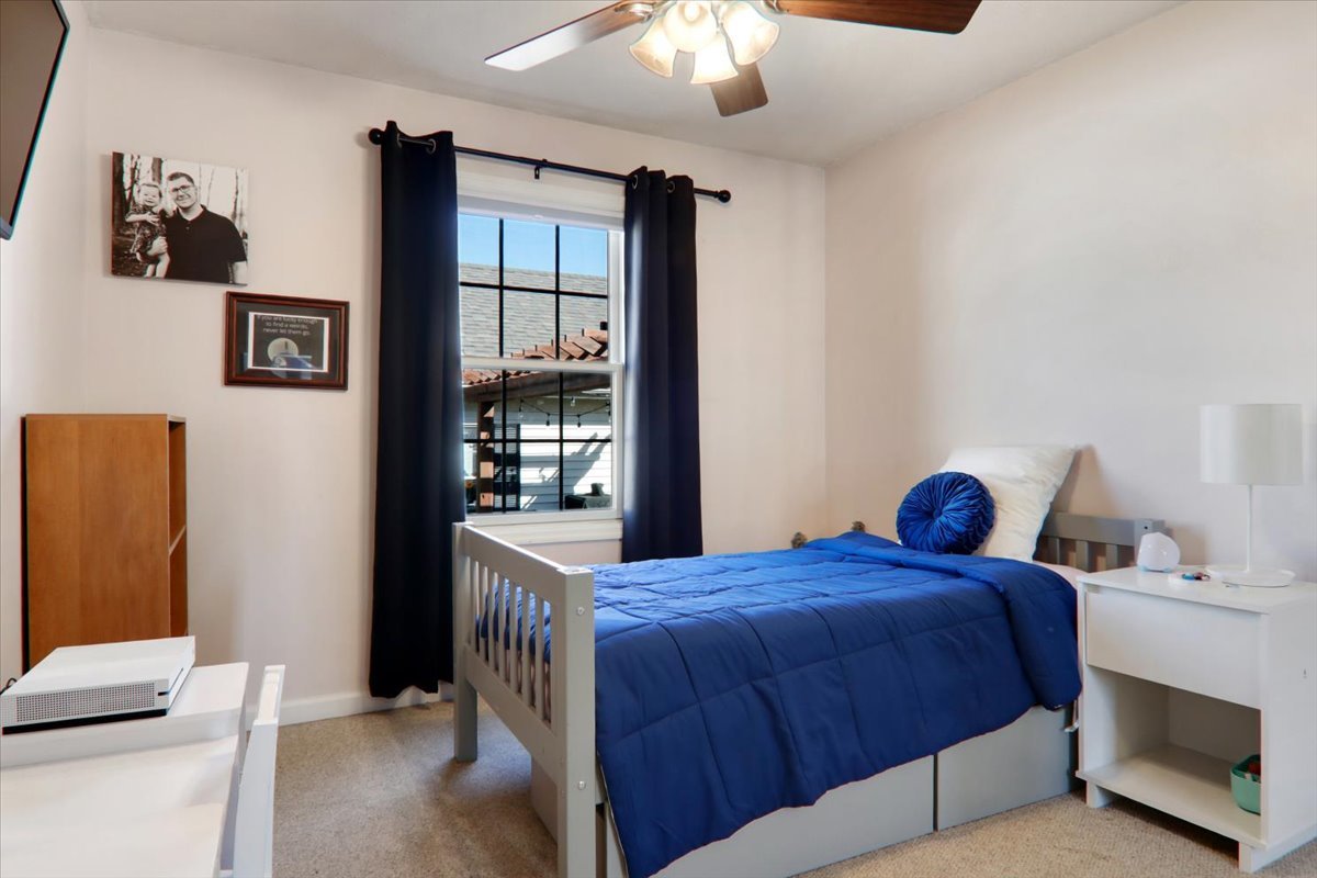 910 Drayton Street Normal, IL 61761 - Photo 15 of 30 a bedroom with a bed and a chandelier