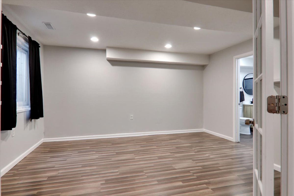 910 Drayton Street Normal, IL 61761 - Photo 19 of 30 wooden floor in an empty room with a window