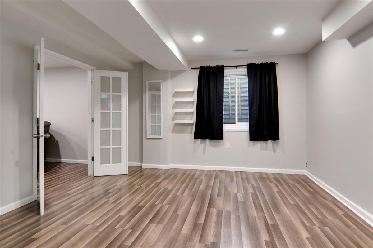 910 Drayton Street Normal, IL 61761 - Photo 20 of 30 a view of an empty room with wooden floor and a window
