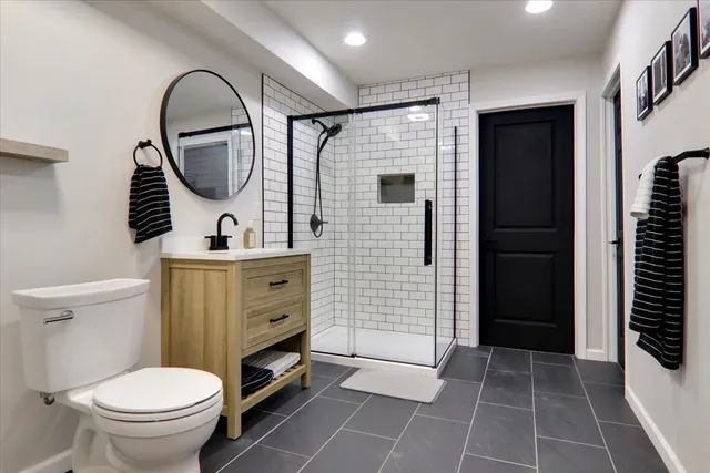 a bathroom with a toilet a sink and a mirror