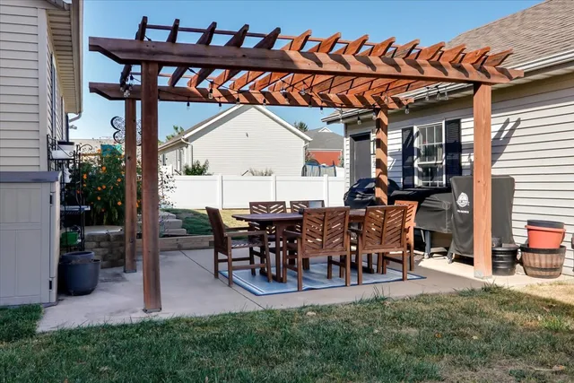 a view of a porch with dining table and chairs