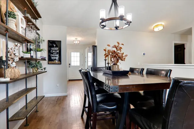a view of a dining room with furniture and chandelier