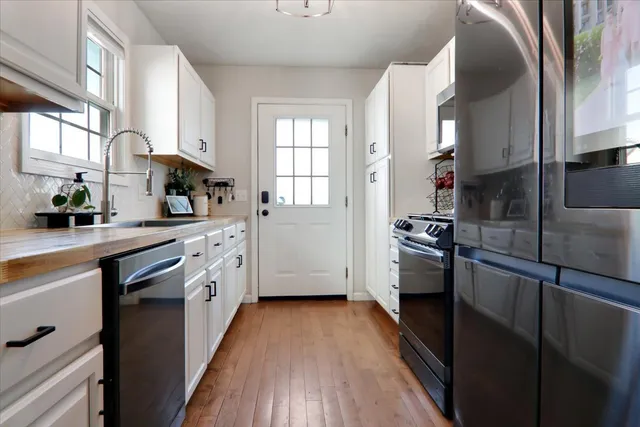 a kitchen with stainless steel appliances a sink stove and refrigerator