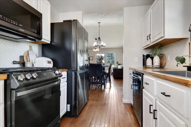 a kitchen with stainless steel appliances a stove a sink and a refrigerator