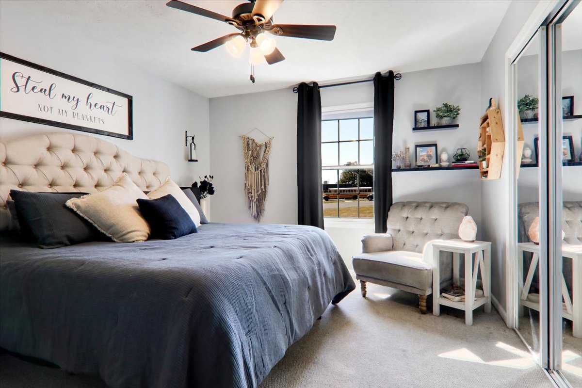 910 Drayton Street Normal, IL 61761 - Photo 9 of 30 a bedroom with a bed and a chandelier