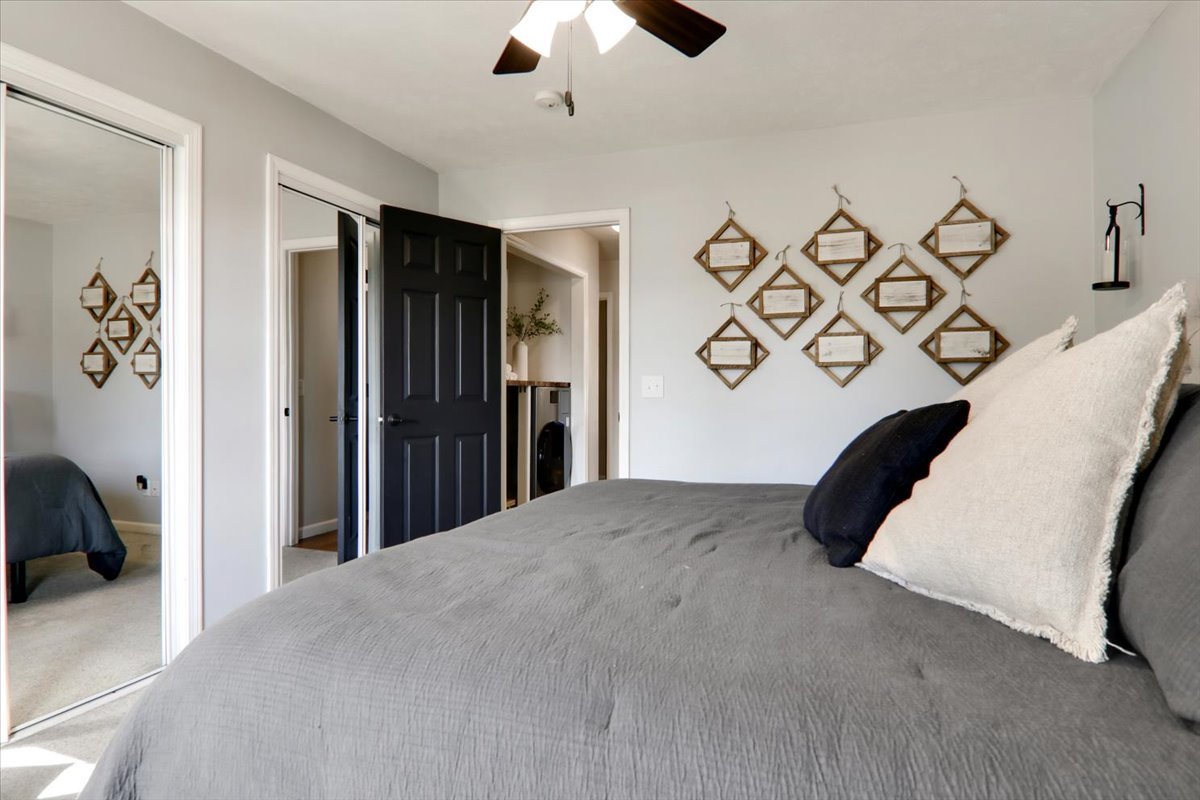 910 Drayton Street Normal, IL 61761 - Photo 10 of 30 a bedroom with a bed and a chandelier