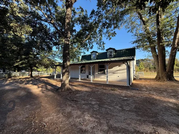 a house that has tree in front of it