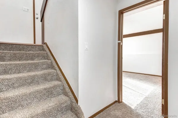 a view of an empty room and stairs