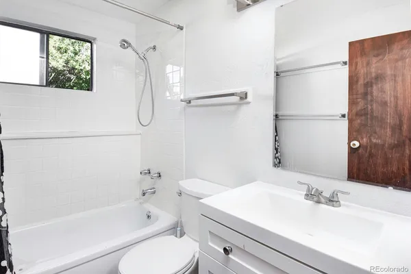 a view of a kitchen with wooden floor and cabinets