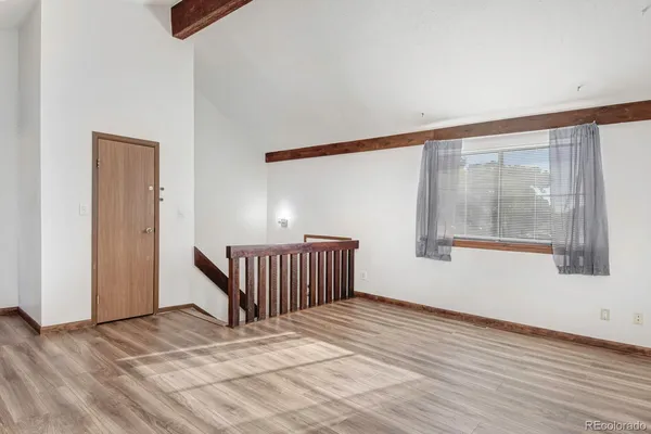 a view of a hallway view with wooden floor and staircase
