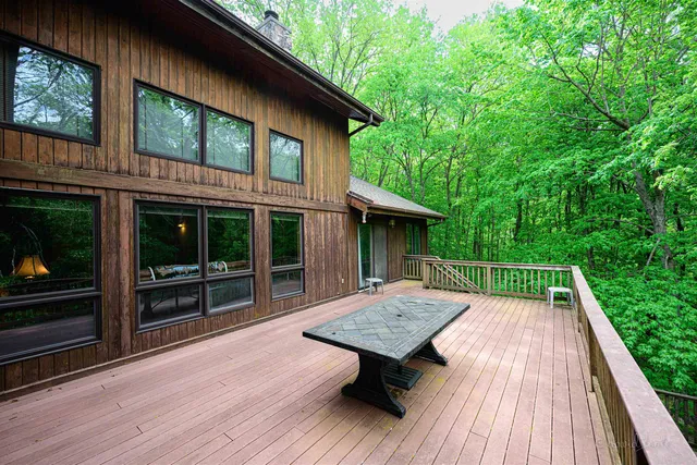 a view of backyard with a deck and wooden floor