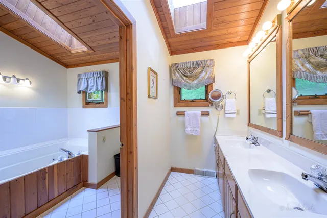 a bathroom with a sink a vanity and a bathtub