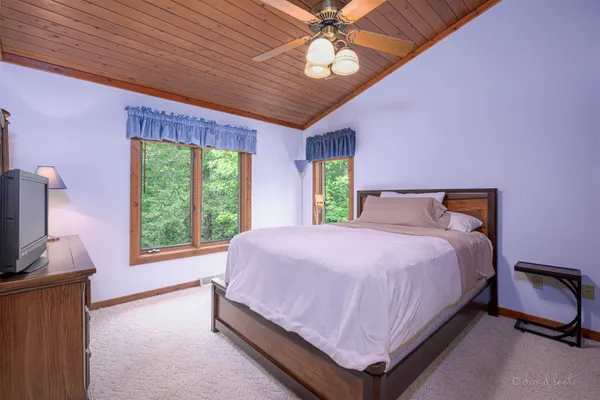 a spacious bedroom with a bed and a couch