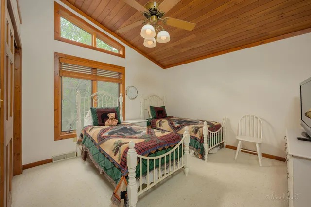 a bedroom with a bed a chandelier and a chandelier