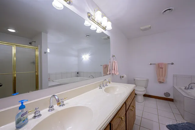 a bathroom with a sink double vanity and a mirror