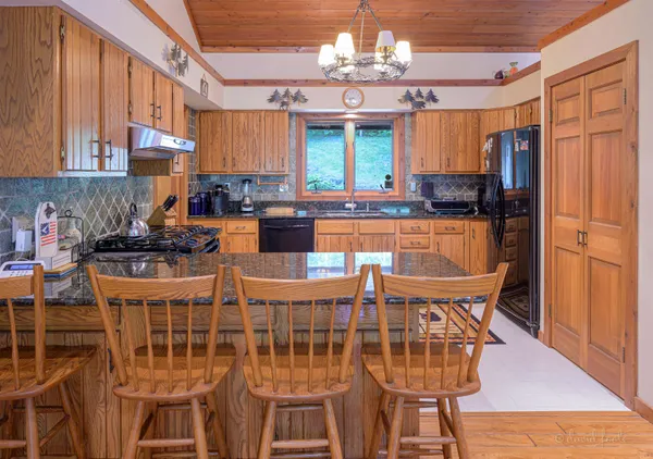 a bed room with a bed mirror and a flat tv screen on dresser