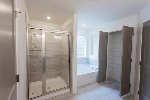 a bathroom with a glass shower door