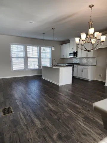 a view of a kitchen with a dishwasher cabinets and wooden floor