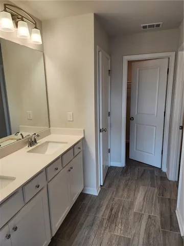 a bathroom with a double vanity sink and mirror