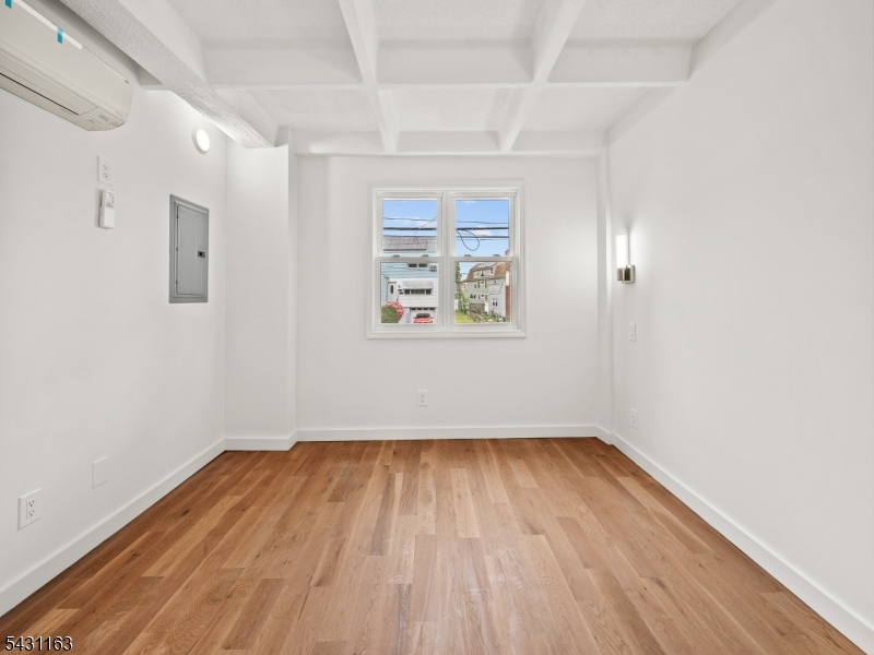 100 Chestnut Street, Unit 3 West Orange, NJ 07052 - Photo 7 of 18 a view of empty room with wooden floor and fan