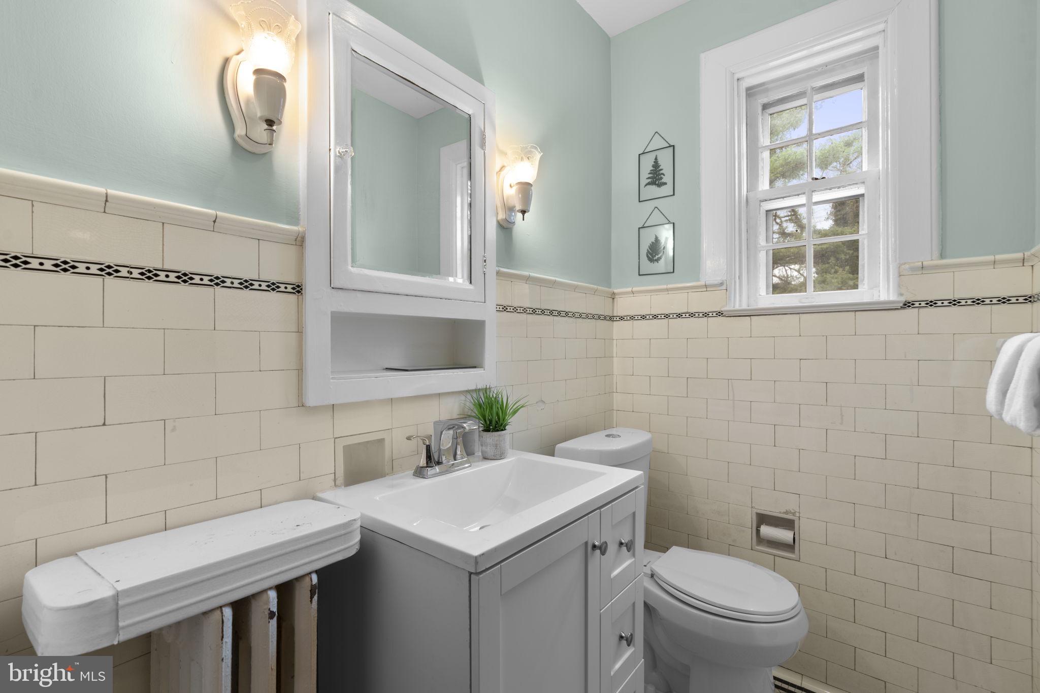 414 Old Orchard Road Baltimore, MD 21229 - Photo 28 of 84 a bathroom with a sink a toilet and mirror