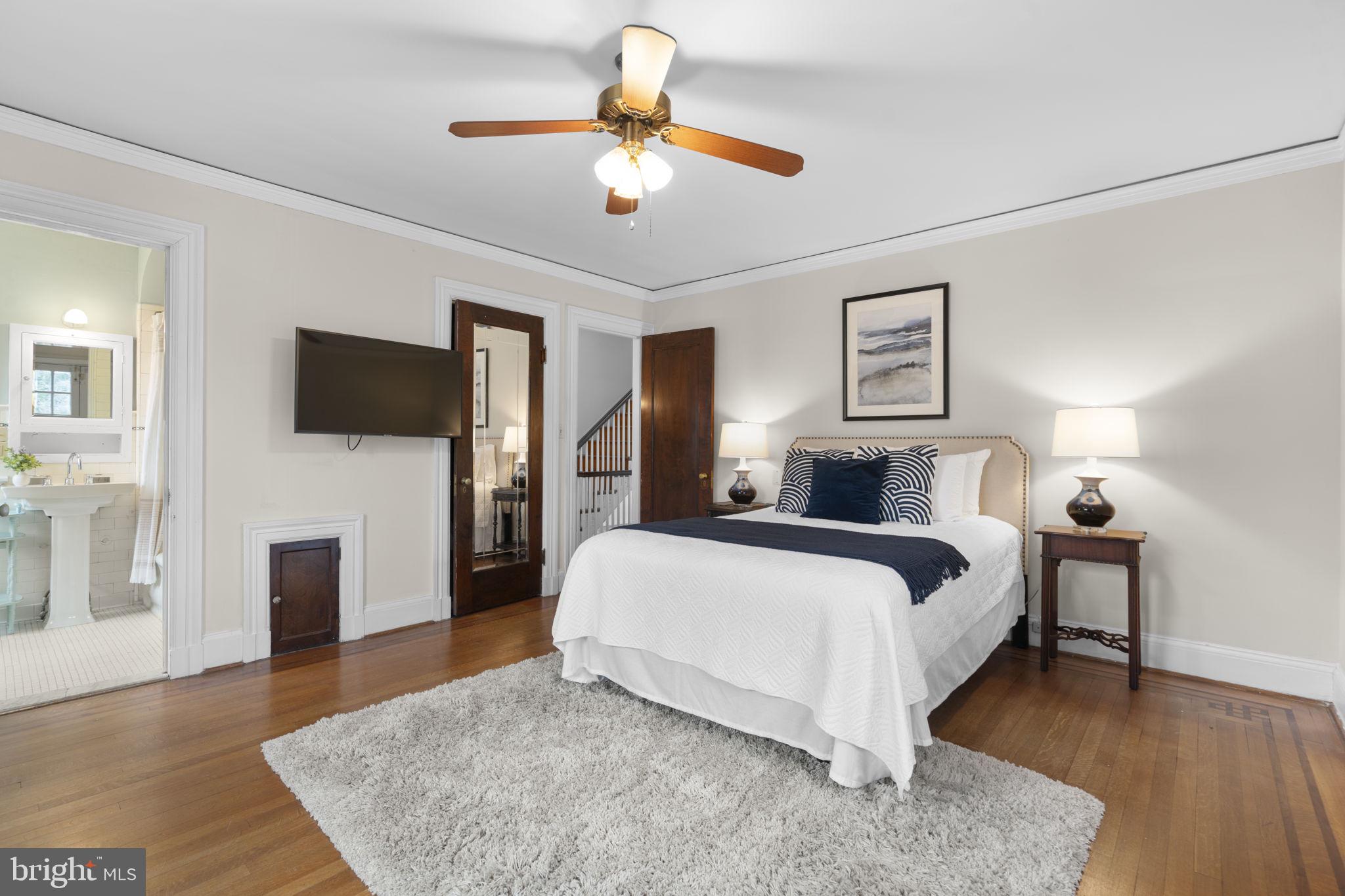 414 Old Orchard Road Baltimore, MD 21229 - Photo 29 of 84 a spacious bedroom with a bed and a flat screen tv