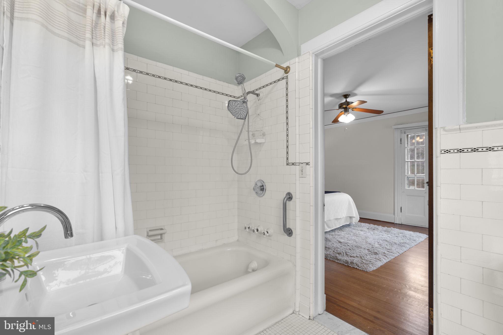 414 Old Orchard Road Baltimore, MD 21229 - Photo 32 of 84 a bathroom with a granite countertop bathtub shower and mirror