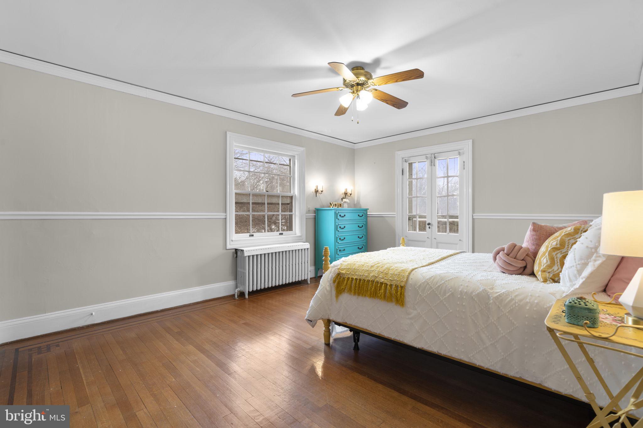 414 Old Orchard Road Baltimore, MD 21229 - Photo 35 of 84 a bedroom with a bed and a chandelier